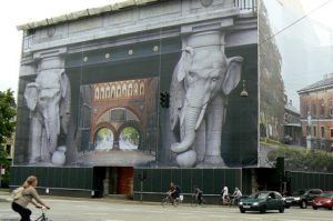 Decorative scaffolding covering on a building under restoration.