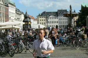 Waiter attending tables at outdoor cafe in Gammeltorv Square.  Most