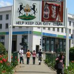 Harare: downtown business district - central park sign: Sunshine City