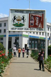 Harare: downtown business district - central park sign: Sunshine City