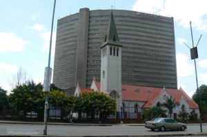 Harare: downtown business district - church backed by a hotel