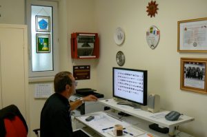 Meuse-American Cemetery--assistant superintendant Dominick showing vintage photos of the cemetery's