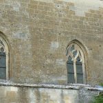 Detail of the church exterior wall showing numerous bullet holes