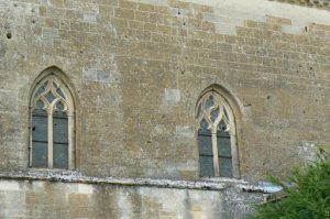 Detail of the church exterior wall showing numerous bullet holes