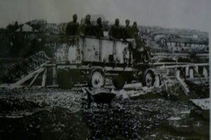 Troops crossing a rebuilt local wooden bridge 1917-18