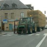 Main street of Vouziers with big hay load