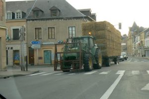 Main street of Vouziers with big hay load
