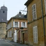 Restored period houses in Vouziers with Church of St Maurille