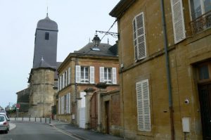 Restored period houses in Vouziers with Church of St Maurille