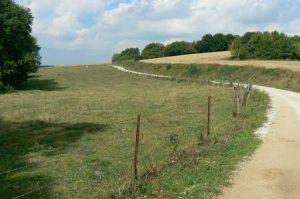 A dirt road leads uphill (north) behind St Georges where