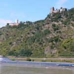 Countless barges plow the river with heavy cargos past ancient