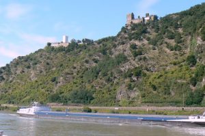 Countless barges plow the river with heavy cargos past ancient