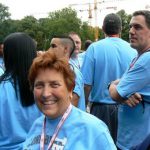 Athletes (Andrea from Long Beach, California) gather outside to form