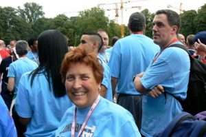 Athletes (Andrea from Long Beach, California) gather outside to form