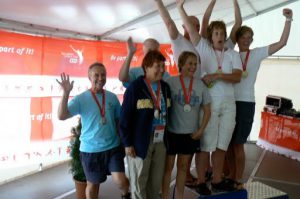 Team Long Beach relay swim team (left) celebrates their medals