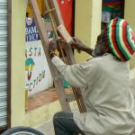 Street artist-weaver at work