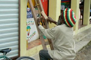 Street artist-weaver at work