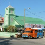 Green church and colored bus