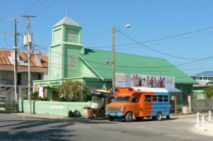 Green church and colored bus