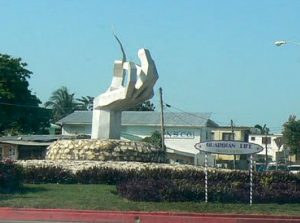 Sculpture of a hand holding a palm leaf