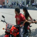 Modern generation--motorbike (with religious decal) and pizza to go