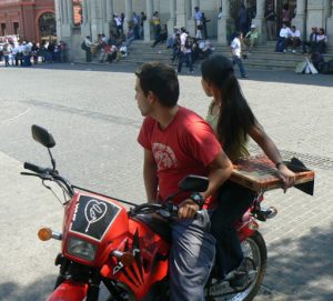 Modern generation--motorbike (with religious decal) and pizza to go