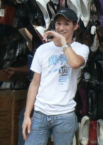 Androgynous face of a guy selling shoes