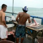 Customer waiting for fresh fish to be cut