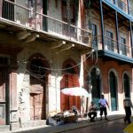 Unrestored and restored buildings stand next to each other