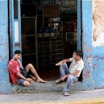 Local guys hanging out in front of a store