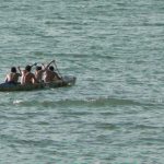 Rowing team in a dug-out canoe