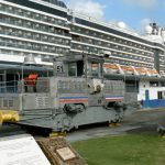 Ship passing through the Panama Canal pulled by a locomotive