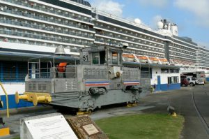 Ship passing through the Panama Canal pulled by a locomotive