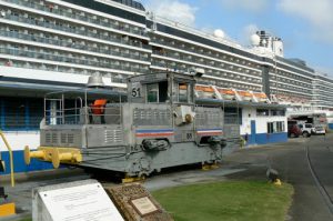 Ship passing through the Panama Canal pulled by a locomotive