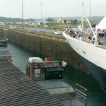 Ship passing through the Panama Canal pulled by locomotives