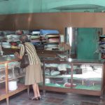 Quiet fabric store; women hold their purses close to guard