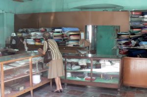 Quiet fabric store; women hold their purses close to guard