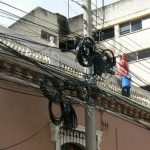 A maze of wires and worker with whitewash