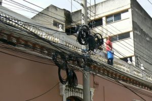 A maze of wires and worker with whitewash