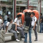Students hanging out along pedestrian street downtown