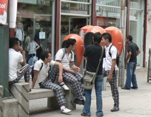 Students hanging out along pedestrian street downtown