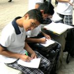 Students doing homework along pedestrian street