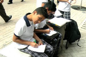 Students doing homework along pedestrian street