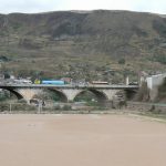 Soccer field with bridge in background