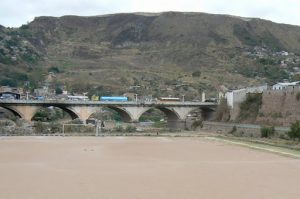 Soccer field with bridge in background