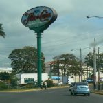 Tall advert sign for Flor de Cona in front of