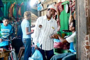 Market faces: butcher greets a friend