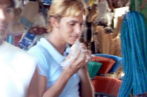 Market faces: gay guy sipping water from a plastic bag