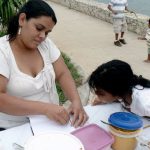 Vendor/Mom helping her daughter with homework