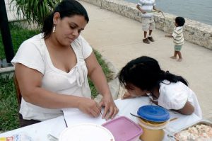 Vendor/Mom helping her daughter with homework